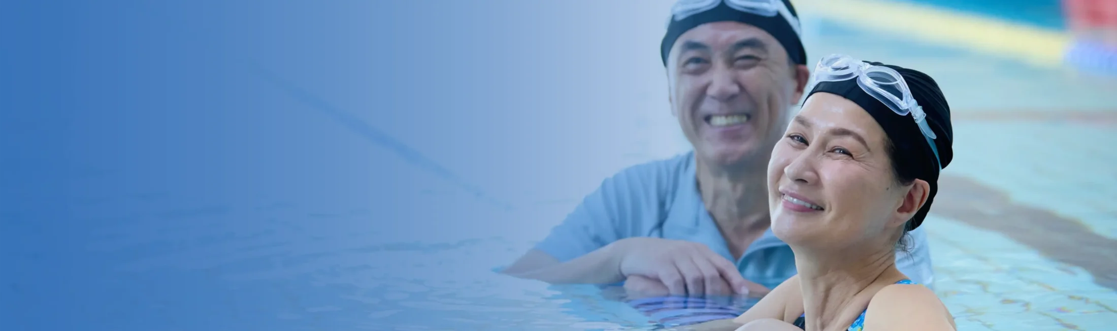 man & woman swimming in water with goggles